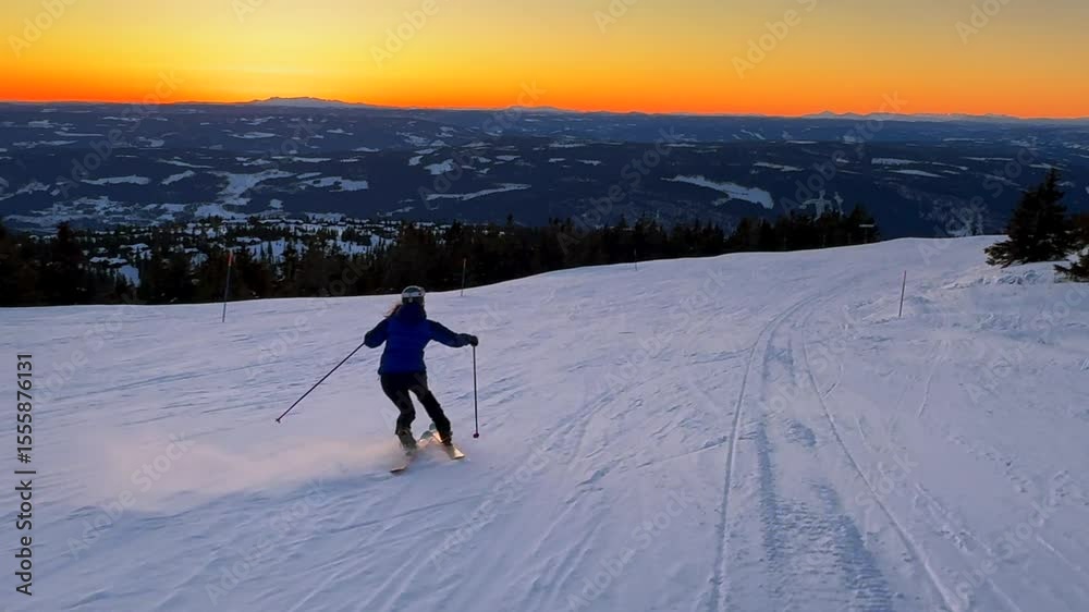 Telemark downhill skier skiing Hafjell Alpine ski resort Øyer mountain Norway Norge vibrant artic sunset golden hour Olympic torch man Lillehammer clear skies groomed trail runs icy packed follow