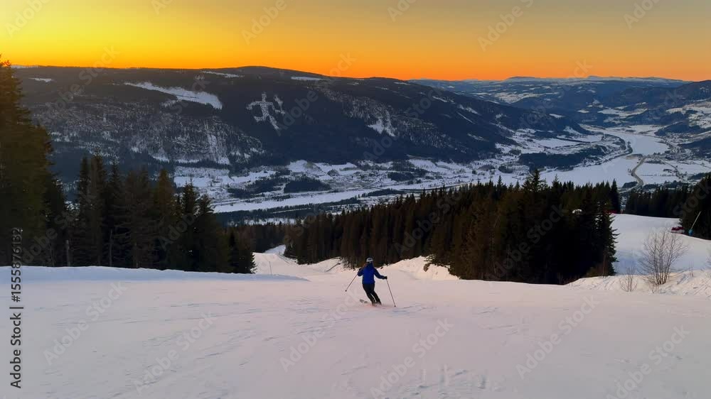 Vibrant artic sunset golden hour telemark downhill skier skiing Hafjell Alpine ski resort Øyer mountain Norway Norge Olympic torch man Lillehammer clear skies groomed trail runs icy packed follow