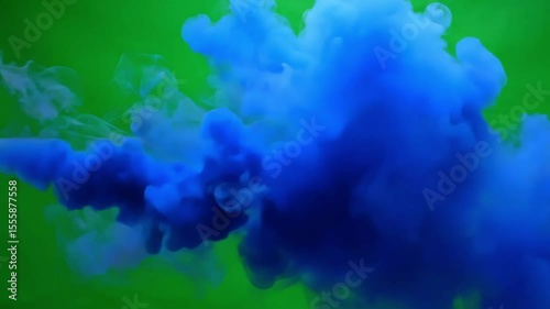 Captivating blue ink swirling in green background perfect for abstract visuals and presentations