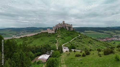 Drone footage flying towards ancient Slovak castle ruins from a distant scenic view. Perfect for travel and history content. No audio.