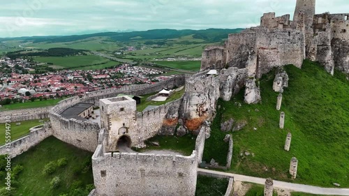 Cinematic 4K drone flying along and above medieval Slovak castle ruins. Smooth vertical motion over structure. No audio.