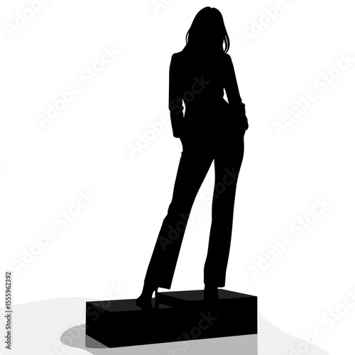 Silhouette of a woman standing confidently on a pedestal  
