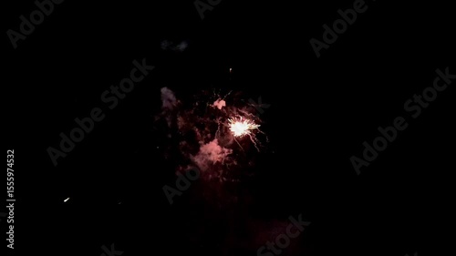 Colorful holiday fireworks bursting in the night sky during a festive celebration