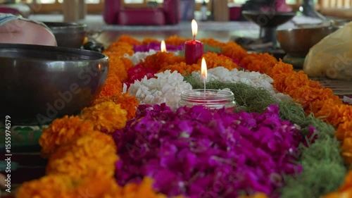 of flowers and candles sits on a wooden floor before a spirit cleaning ceremony
