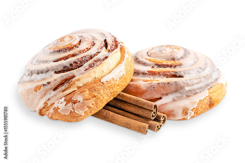 Close up view of two delicious sweet homemade cinnamon rolls bun or swirl dessert glazed with sugar icing with spice sticks isolated on white background served for morning breakfast as baked pastry 