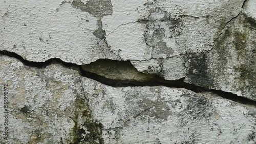 Old concrete wall texture large crack and dirty wall surface with large damage.