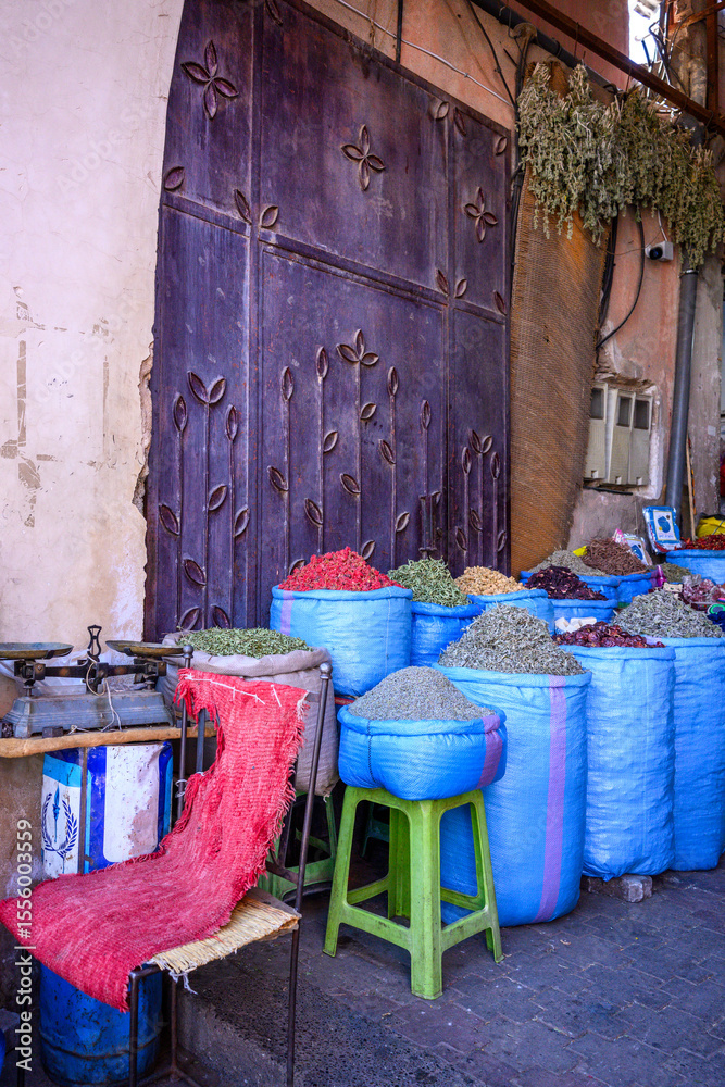 Obraz premium Colourful bags of dried spices waiting to be weighed in an alley in the spice souk in Marrakech, Morocco