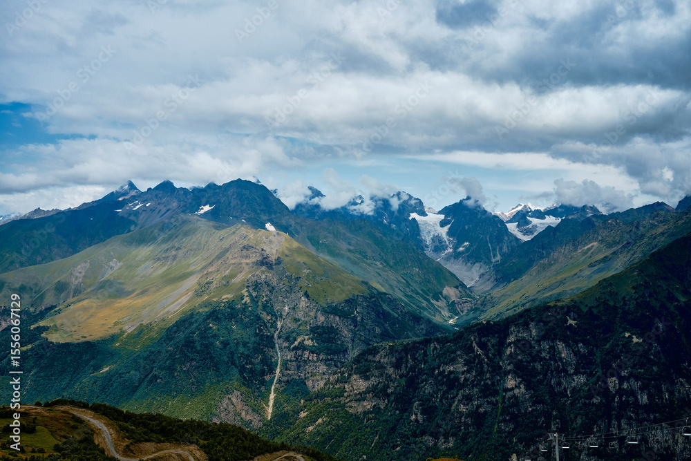 Fototapeta premium Mountain ranges on a sunny day at Georgia. Sky with clouds adn hills