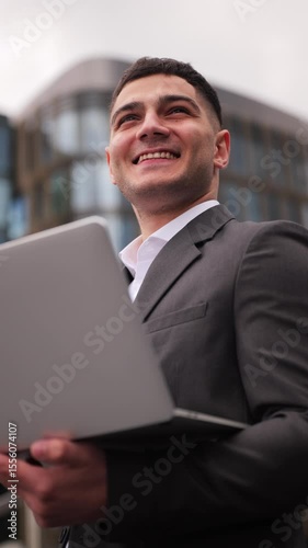 Engaging professional reviews work on laptop in modern urban setting during daytime