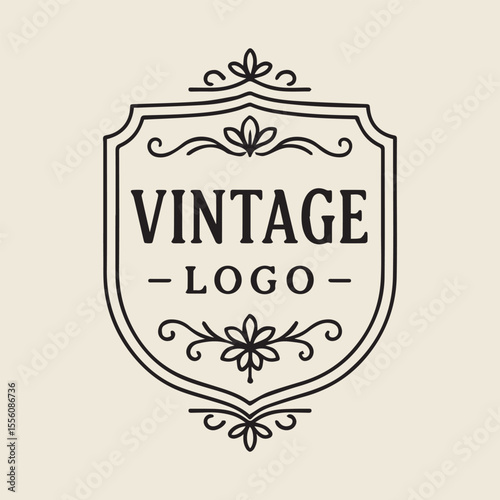 Elegant Vintage Logo Design with Ornate Flourishes and Classic Shield Shape