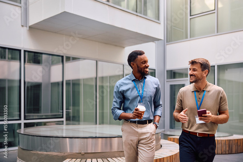 Happy entrepreneurs communicating on their coffee break at work.