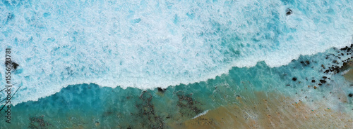 Banner Turquoise ocean sea water white wave pattern splashing deep blue sea. Banner Tropical sea beach Seascape dark background wave splash on rock. Summer Ocean Surface big wave with copy space