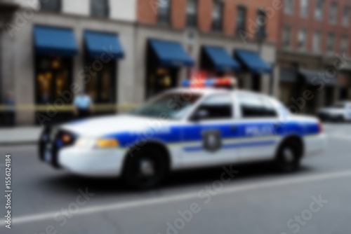 Blurry photo of a police car patrolling the busy city center.