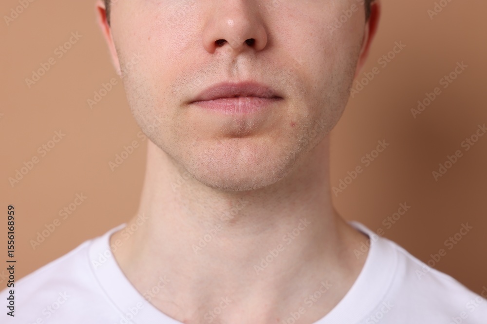 Obraz premium Man after shaving on beige background, closeup