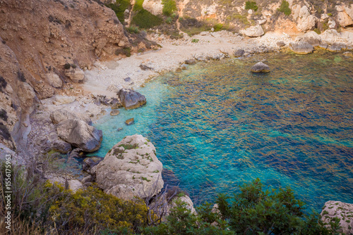 A small bay with turquoise waters on the island of Sardinia.