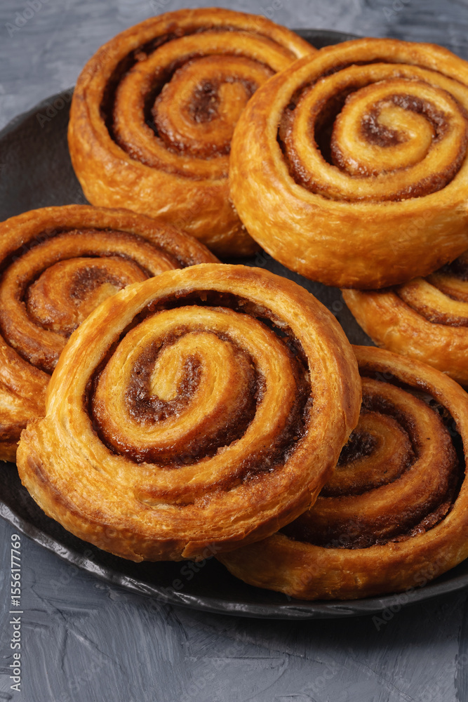Fototapeta premium Tasty cinnamon rolls on table, closeup