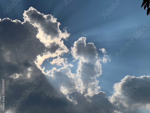 Принти на полотні Sun Rays Beaming Through Clouds against Blue Sky