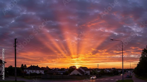 Dramatic Sunset Sky With Radiant Orange And Red Hues Over Residential Area