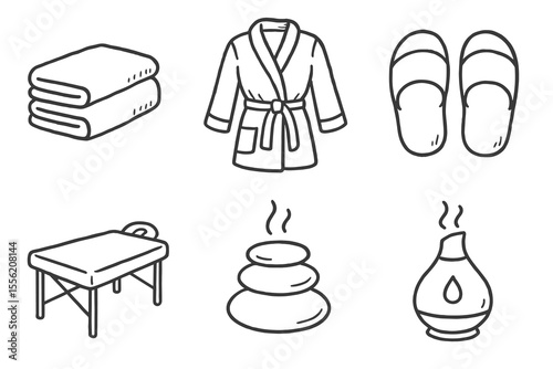 Spa essentials: towels, robe, slippers, massage table, stones, diffuser