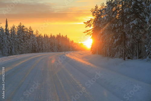 Bright Colorful Winter Polar Night Sunset over road in Lapland, Finland