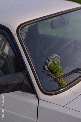 Wildflower Bouquet on Car Windshield. Romantic Surprise in the Countryside