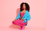 Fashionable portrait of beautiful Brazilian woman in stylish outfit on pink background
