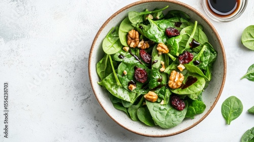 Vibrant Salad Composition: A fresh and inviting salad, artfully arranged with spinach, walnuts, and cranberries, presenting a visual and culinary delight. 