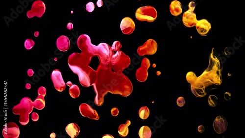 red and yellow color drops dripping animation on black screen. Liquid splashes and drops in motion on black background.
