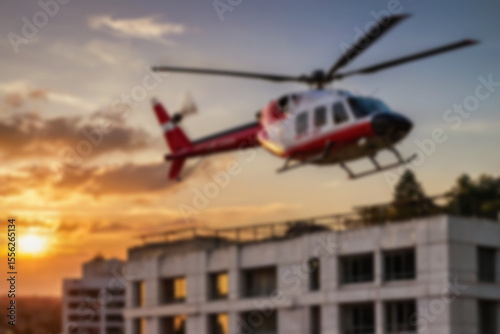 A blurry photo of a medical helicopter flying low over a city to pick up a patient.