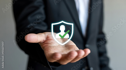 Business professional presenting a glowing shield with a person icon and checkmark symbolizing personal data protection