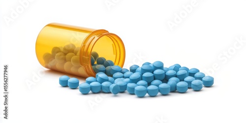 Blue and yellow pills spill from an open yellow medicine container against a white surface, indicating prescription drugs in medical settings.