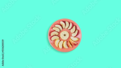 Apple in the plate stop motion animation on blue background. Fruits in the plate animation. Stop motion animation of fruits