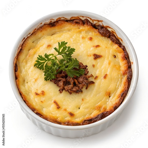 top view of freshly baked escondidinho de carne seca in bowl on white background 