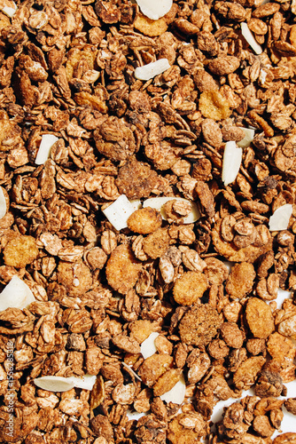 Crunchy granola mix with oats nuts and dried fruits in a bowl for breakfast or snack