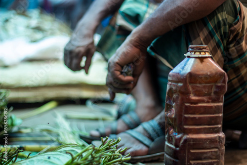 A poor man sitting on the market and show his both hands