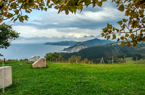 Landscape of rocky beach with hills, mountains and Atlantic Ocean coast of northern Spain, against sky