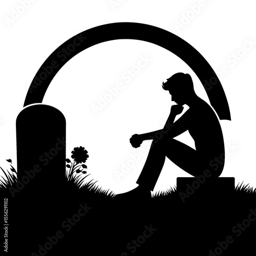 Young man sitting contemplatively by a gravestone in silhouette  