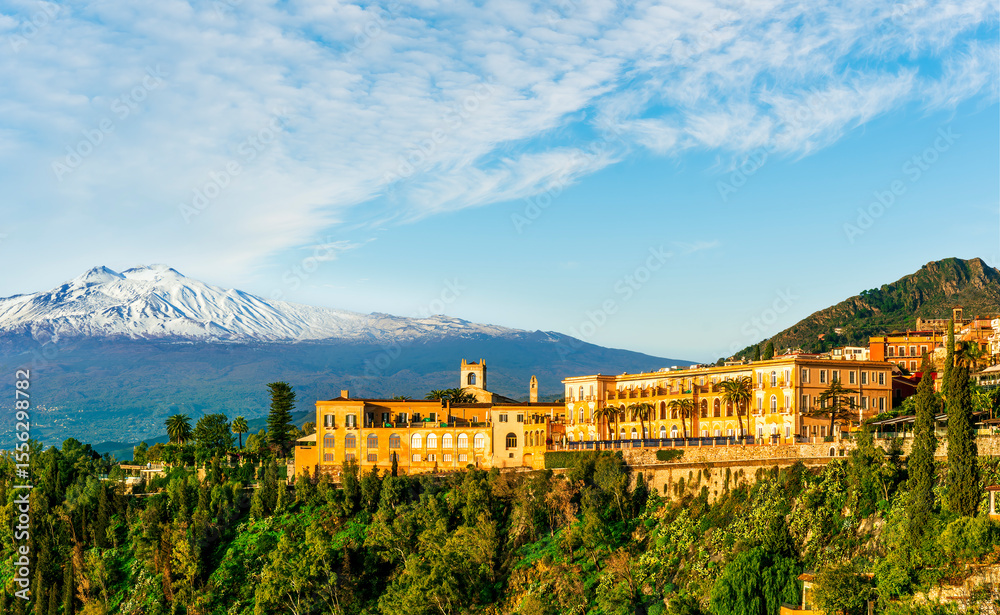 Obraz premium beautiful landscape of Taormina town, Italy, Sicily with scenic view at San Domenico hotel near nice buildings and panoramic view of Etna mountain on background