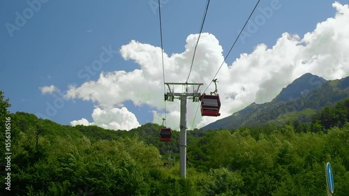 In summer, take a ride on the red funicular, on the cable car. Green forest, bright sunny day, blue sky with clouds