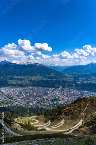Beautiful aerial view of Innsbruck city and Tyrolean alps from Seegruben cable car station in spring on a sunny day, Innsbruck, Austria