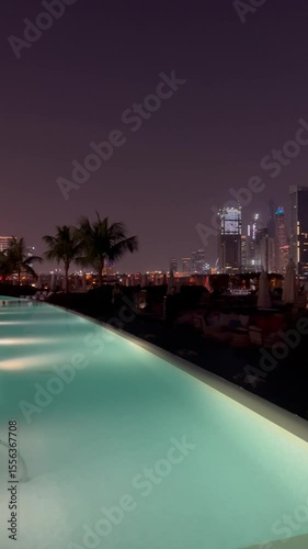 Dubai, UAE - June 25, 2025: Night view of Dubai Palm Jumeirah islands. Skyscraper at night. Beautiful pool and beach. Dubai Marina at night with illuminated buildings. Luxury. Beautiful evening