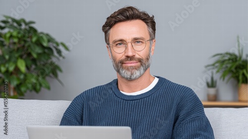 Financial planning retirement tools concept. Professional man working on a laptop, surrounded by greenery, exuding a calm and focused demeanor.