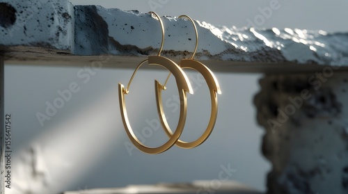 Asymmetrical Gold Hoop Earrings on Concrete Slab