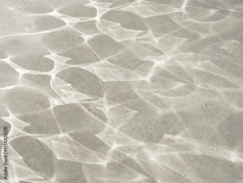 The sun's glare and radiance on the texture of the stone. Background of sunlight, abstract photography with light and shadow, monochrome minimalistic scene. Natural light