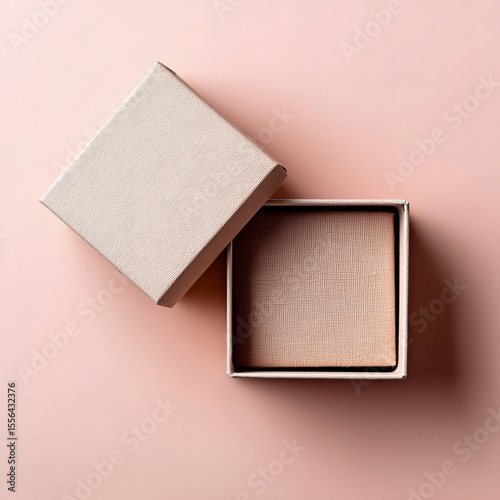 Open small square cardboard gift box on pink background