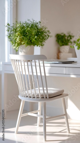 White wooden chair stands near desk in home office with plants