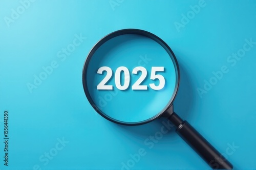 A magnifying glass with the year 2025 written on it, ideal for use in historical or futuristic scenarios..New Year 2026.