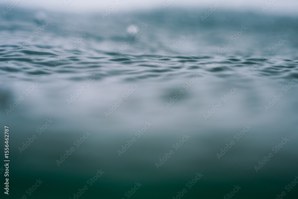 Obraz premium Rain in the sea, raindrops being photographed with a shallow depth of field in the Atlantic Ocean