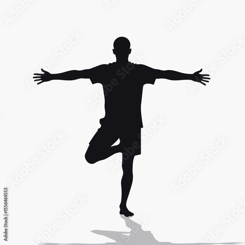 Silhouette of man balancing on one leg with arms extended  