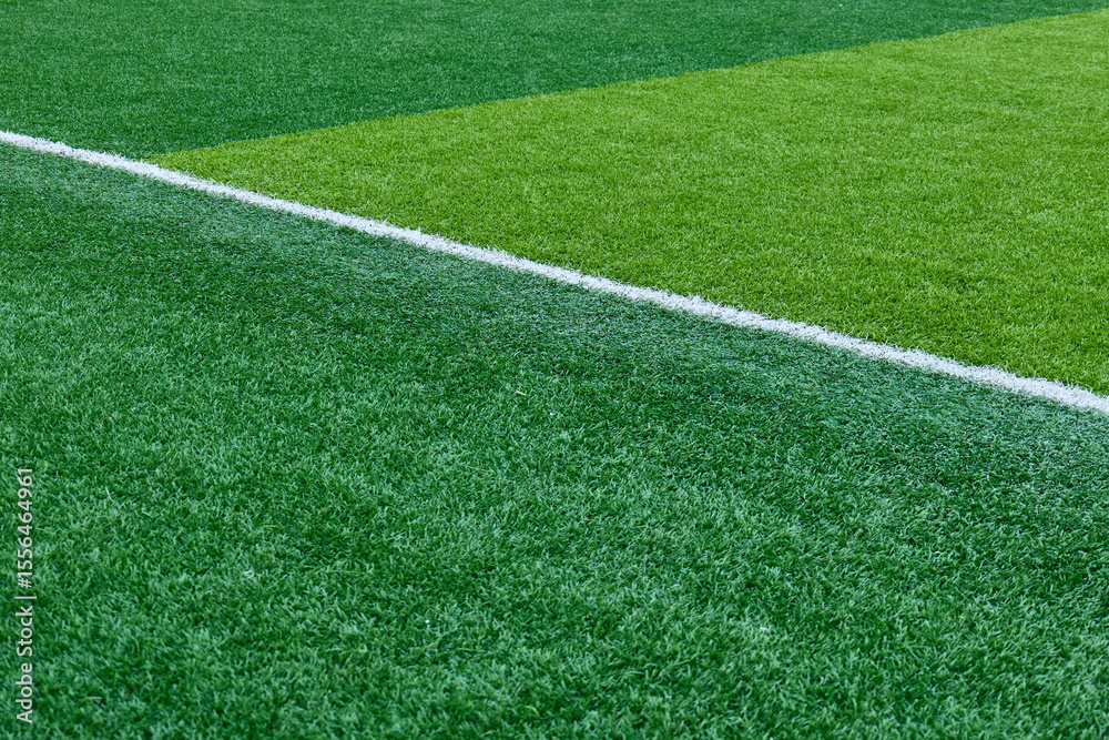 Obraz premium Close up of bright green artificial turf and crisp white markings